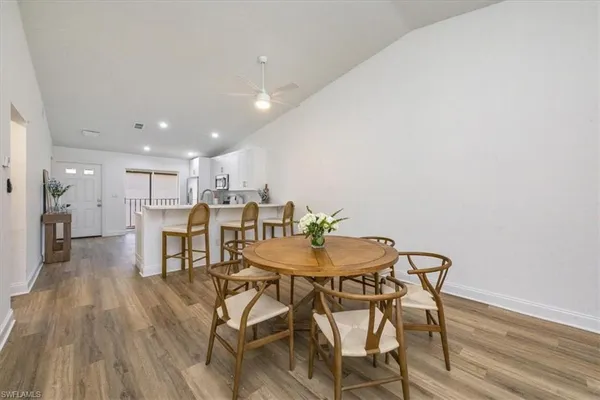 a view of a dining room with furniture and wooden floor