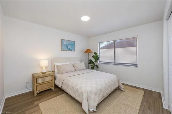 a bedroom with a bed and a night stand