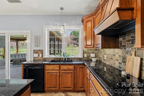 a kitchen with a stove a kitchen island a dining table and chairs with wooden floor