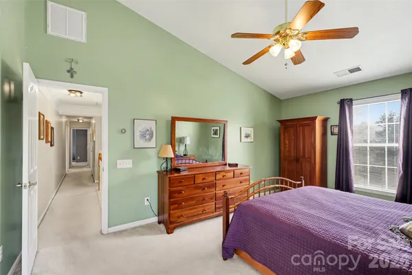 a bedroom with a bed dresser and a window