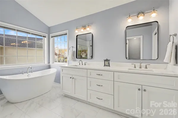 a bathroom with double sink and a mirror