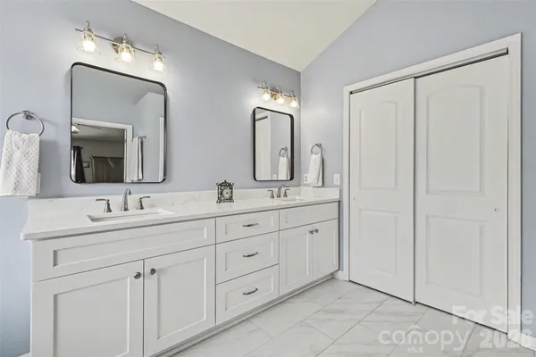 a spacious bathroom with a granite countertop sink and a mirror