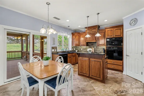 a kitchen with stainless steel appliances granite countertop a sink a stove and a refrigerator