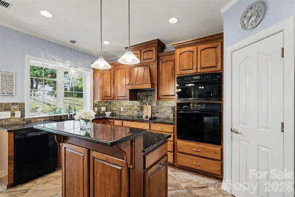 a kitchen with granite countertop a sink and a stove
