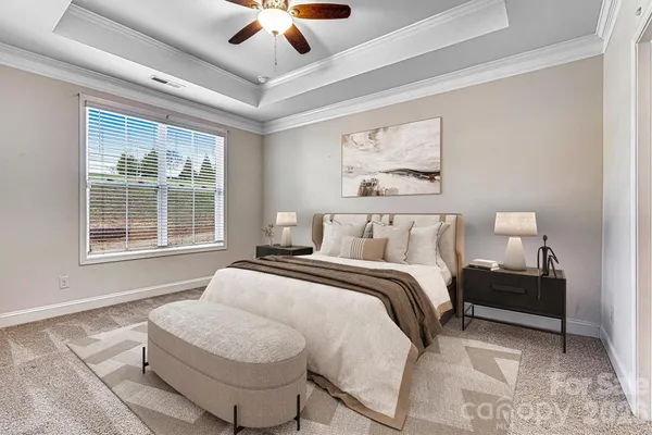 a spacious bedroom with a bed and a large window