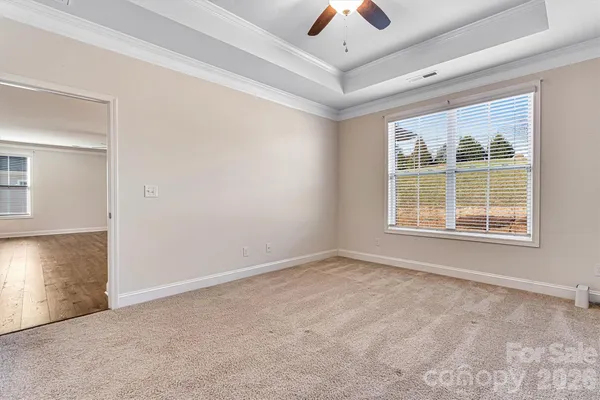 an empty room with windows and closet