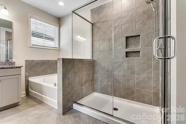 a bathroom with a bathtub and a shower
