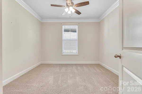 a view of room with window and ceiling fan
