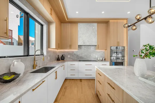 a kitchen with a sink a counter and cabinets