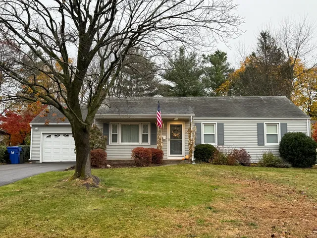 a front view of house with yard and trees