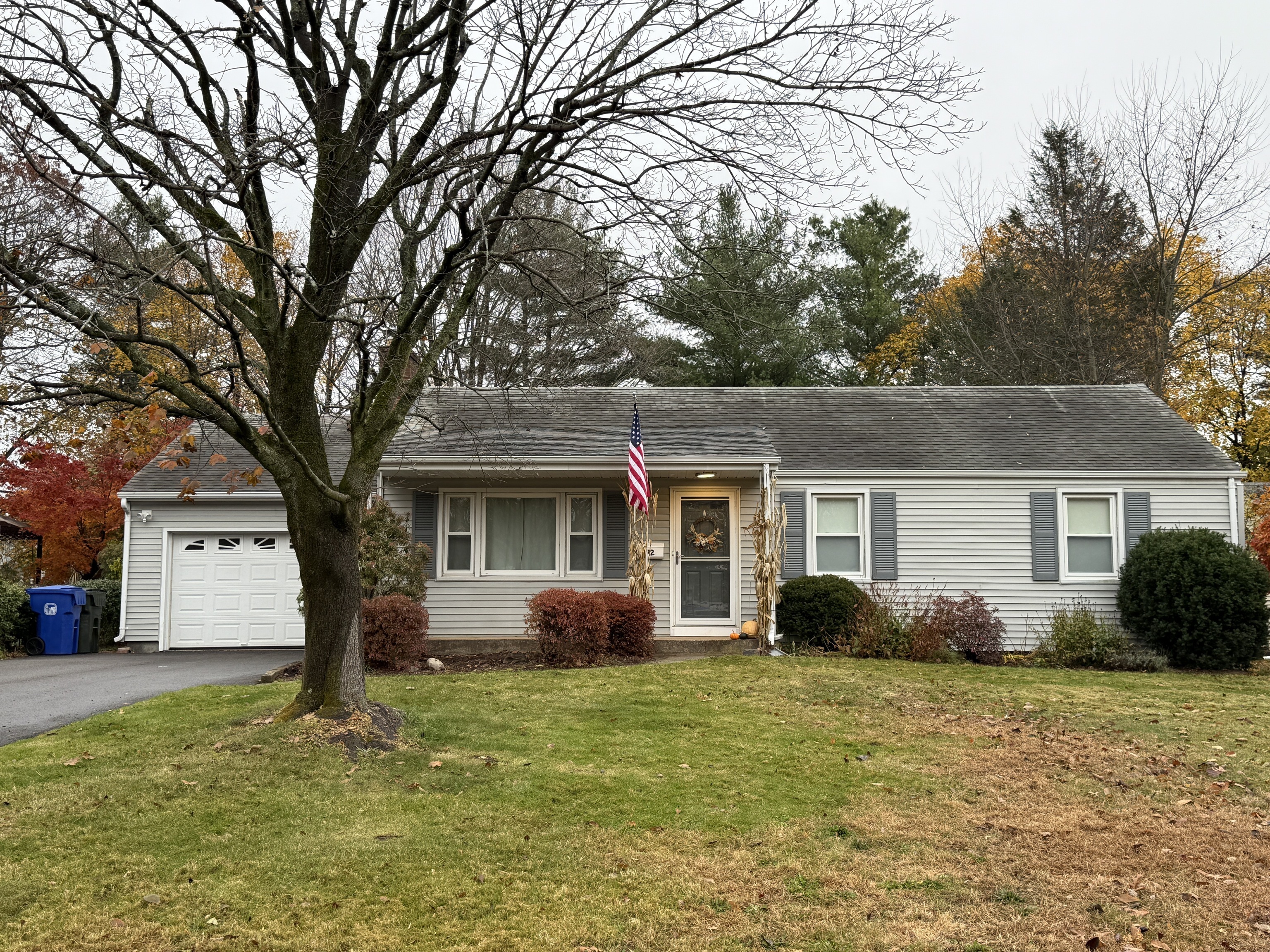 a front view of house with yard and trees