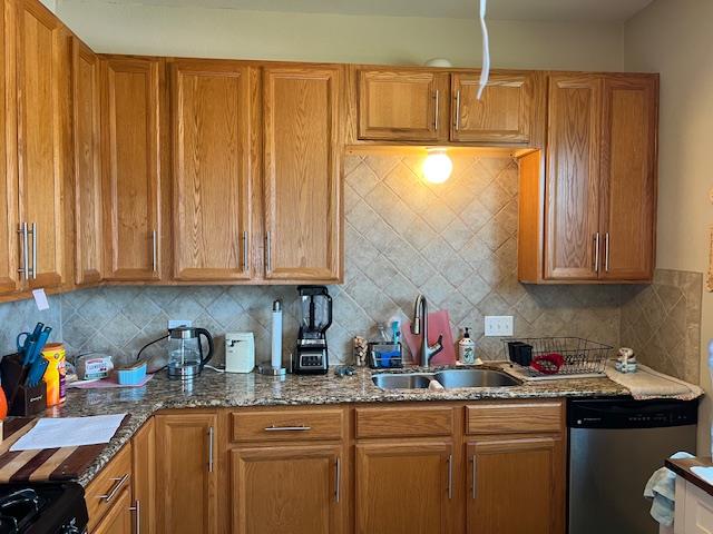 406 West 8th Street Brady, TX 76825 - Photo 11 of 33 a kitchen with stainless steel appliances granite countertop wooden cabinets a sink and dishwasher
