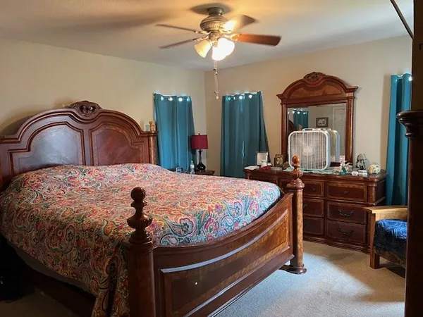 a bed room with a bed and a chandelier