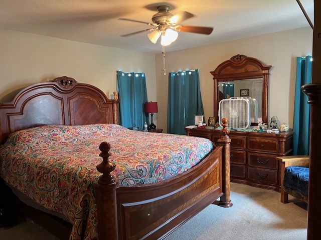 406 West 8th Street Brady, TX 76825 - Photo 15 of 33 a bed room with a bed and a chandelier