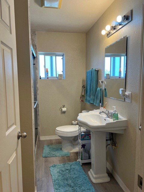 406 West 8th Street Brady, TX 76825 - Photo 18 of 33 a bathroom with a sink a toilet and mirror