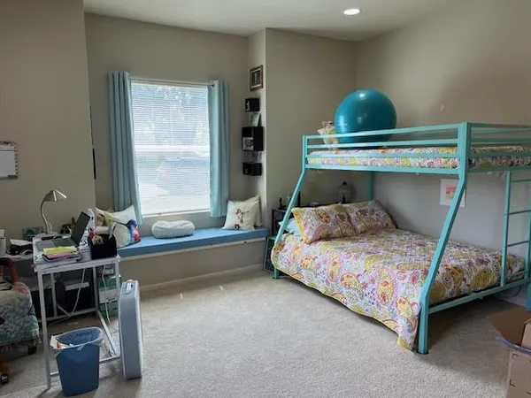a bedroom with a bed and a book shelf