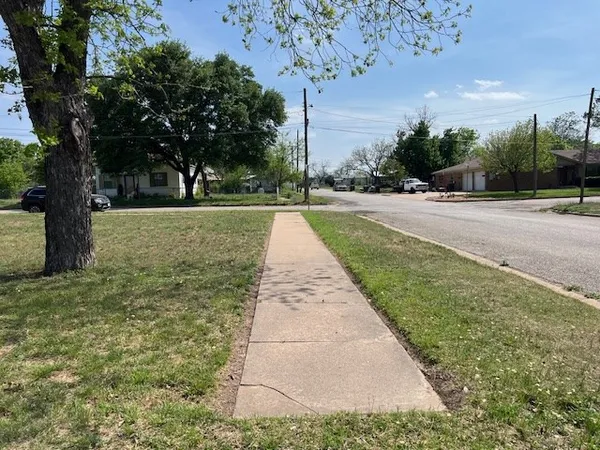 a view of pathway with a yard