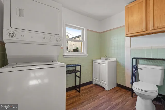 a view of a hallway with wooden floor and entryway