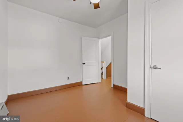 a bathroom with a toilet a sink a mirror and vanity