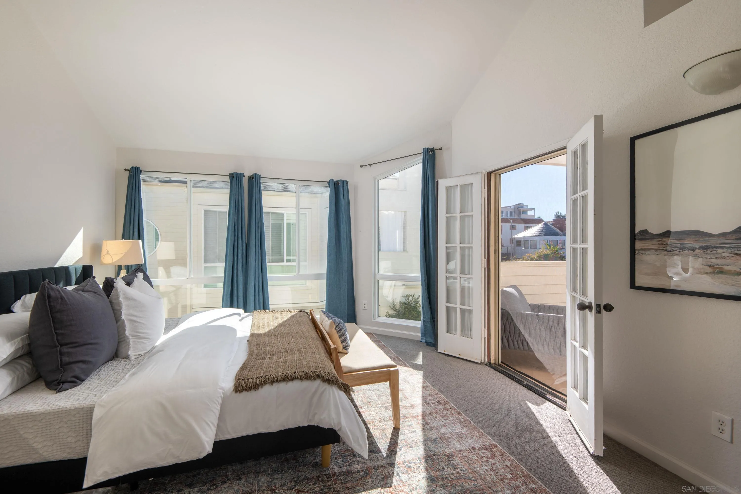 7585 Eads Avenue, Unit E La Jolla, CA 92037 - Photo 1 of 39 a bedroom with a bed and a large mirror