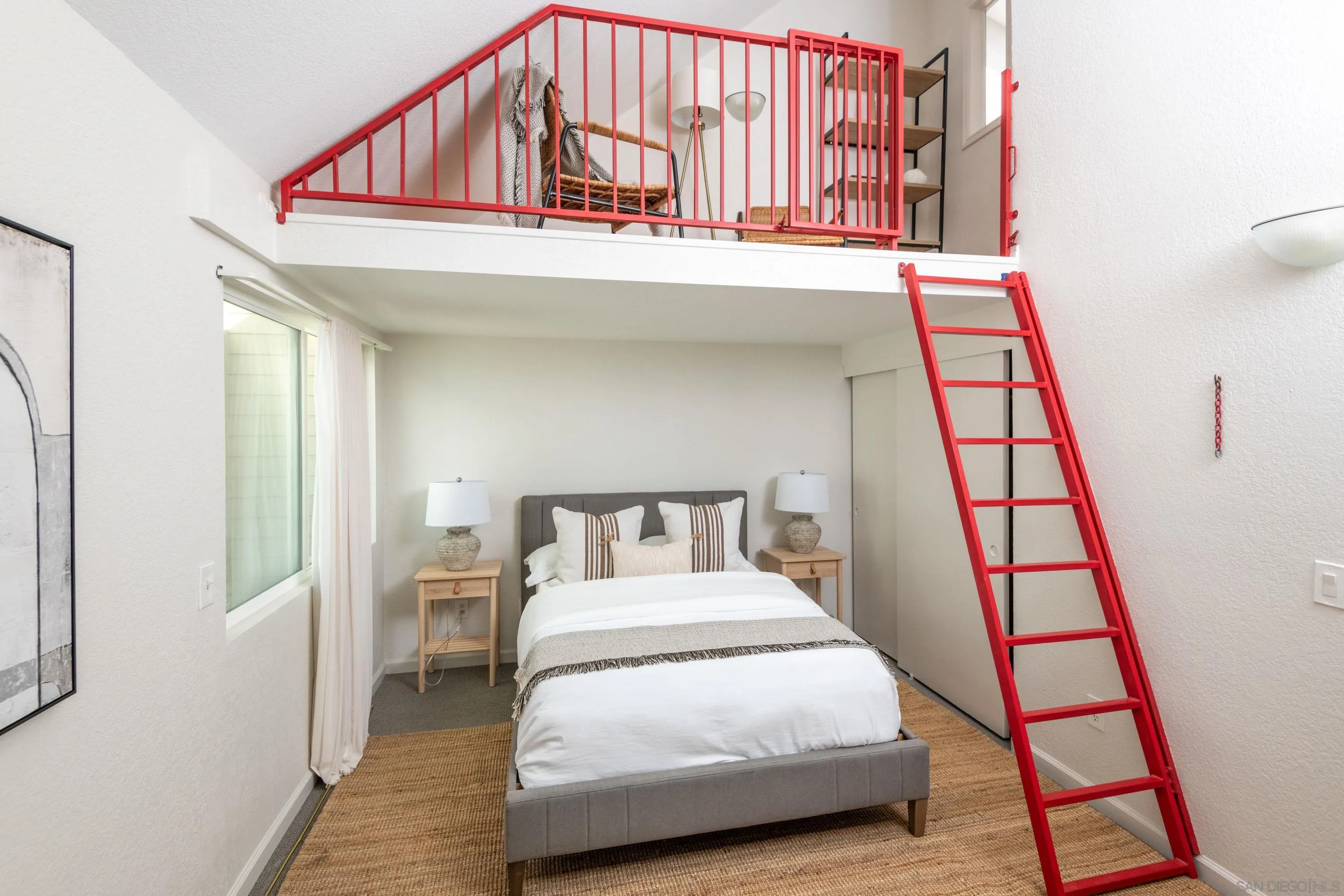 7585 Eads Avenue, Unit E La Jolla, CA 92037 - Photo 19 of 39 a bedroom with a bed and a large window