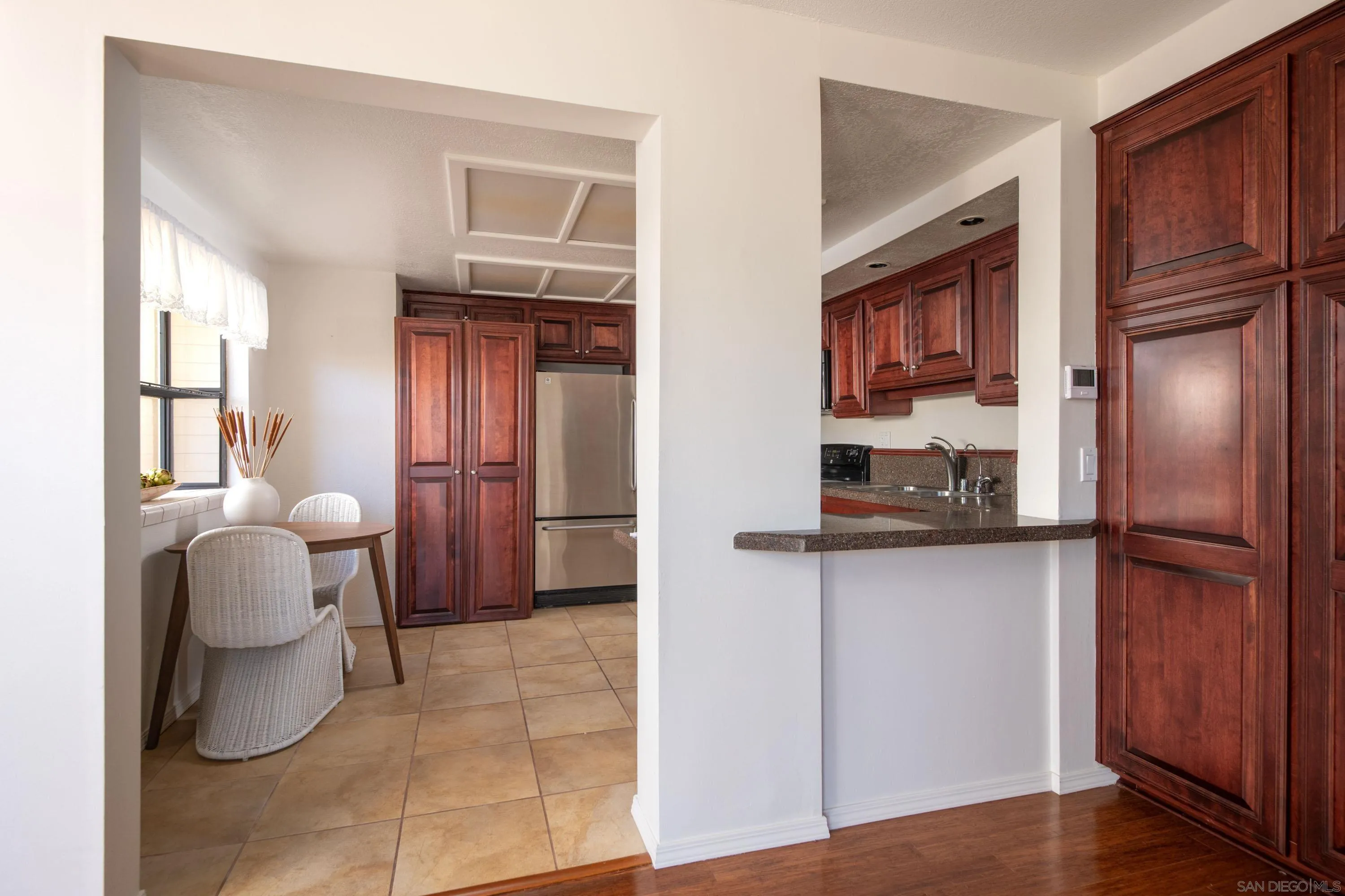 7585 Eads Avenue, Unit E La Jolla, CA 92037 - Photo 9 of 39 a kitchen with a refrigerator and cabinets