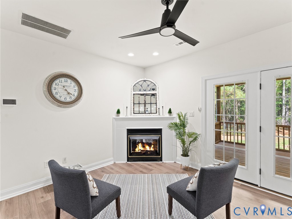 12 Henderson Road New Canton, VA 23123 - Photo 13 of 49 Fireplace with white mantle, wood-finish flooring,