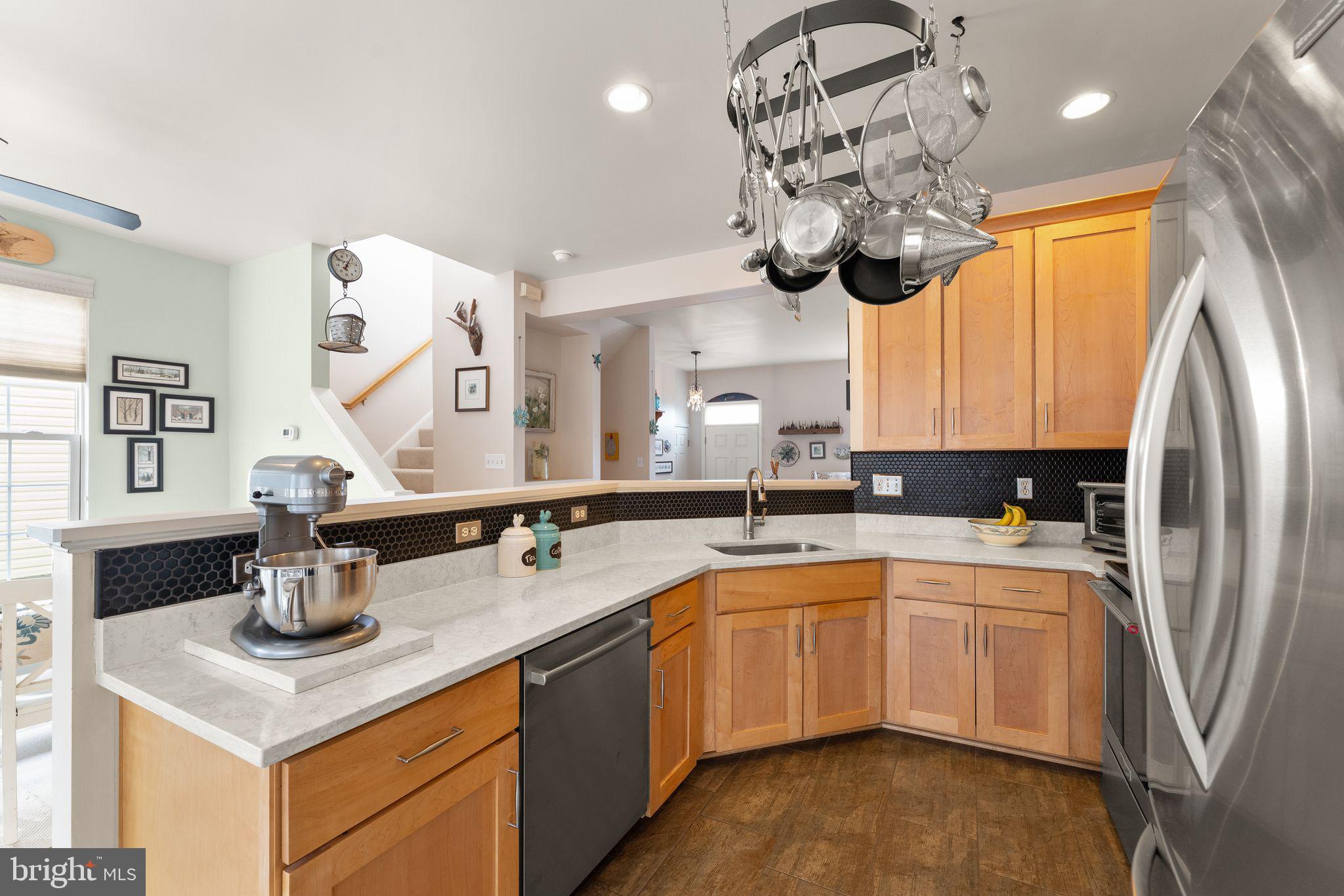 6377 St Timothys Lane Centreville, VA 20121 - Photo 20 of 58 a kitchen with stainless steel appliances granite countertop a sink a stove and a refrigerator