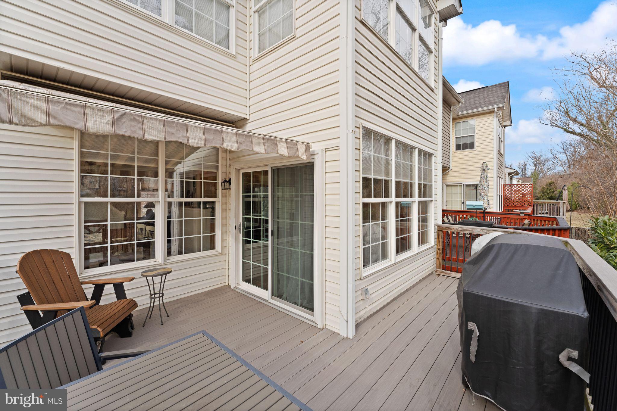 6377 St Timothys Lane Centreville, VA 20121 - Photo 27 of 58 a view of a deck with table and chairs and wooden floor