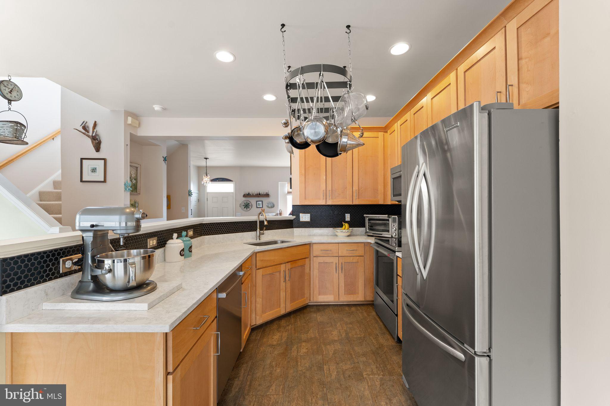6377 St Timothys Lane Centreville, VA 20121 - Photo 4 of 58 a kitchen with refrigerator a sink and a stove