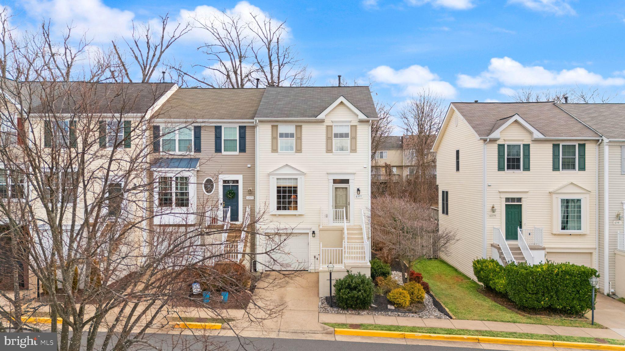6377 St Timothys Lane Centreville, VA 20121 - Photo 54 of 58 a view of a white house with large windows and a table and chairs