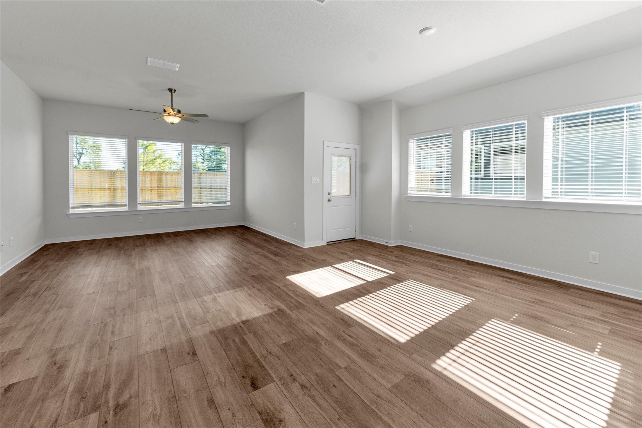 16914 Tulip Row Lane Cypress, TX 77429 - Photo 20 of 48 an empty room with wooden floor and windows