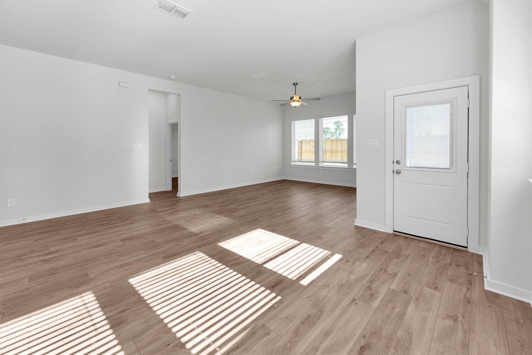 16914 Tulip Row Lane Cypress, TX 77429 - Photo 23 of 48 an empty room with wooden floor and windows