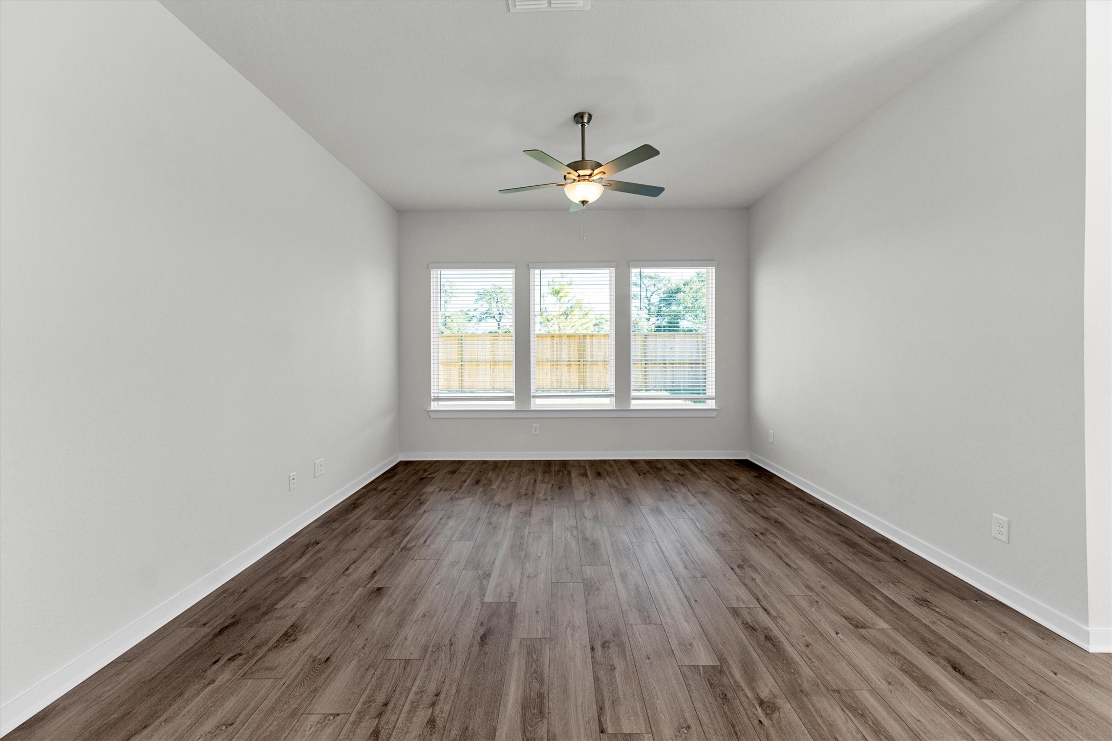 16914 Tulip Row Lane Cypress, TX 77429 - Photo 24 of 48 an empty room with wooden floor ceiling fan and windows