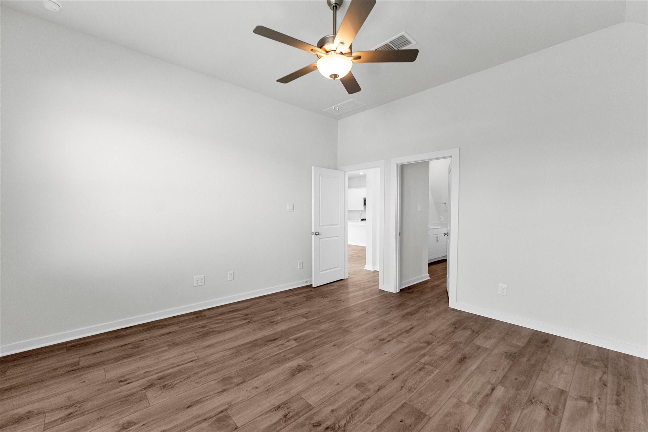 16914 Tulip Row Lane Cypress, TX 77429 - Photo 28 of 48 a view of an empty room and window a ceiling fan and wooden floor