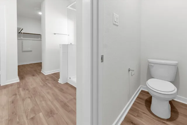 a view of hallway with wooden floor