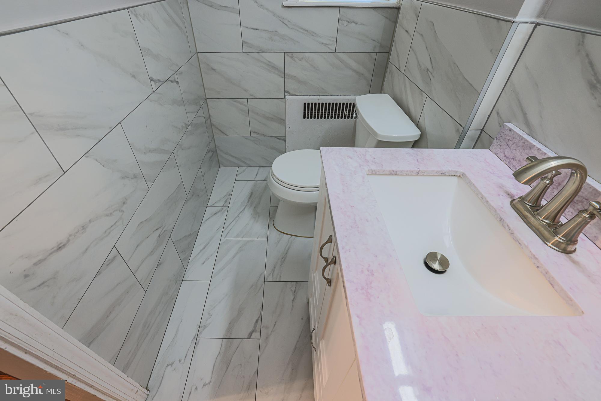 3305 Bancroft Road Baltimore, MD 21215 - Photo 37 of 61 Elegant marble-clad bathroom retreat.