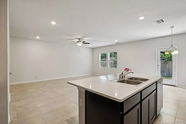 a kitchen with a sink cabinets and wooden floor