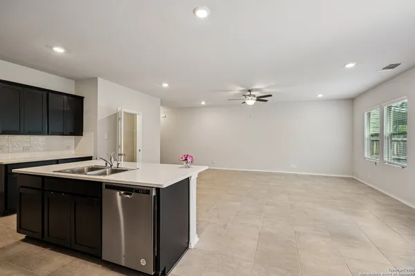 a kitchen with a sink a refrigerator and a microwave