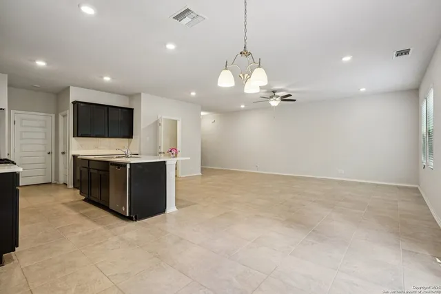 a view of a kitchen with a sink and a stove top oven