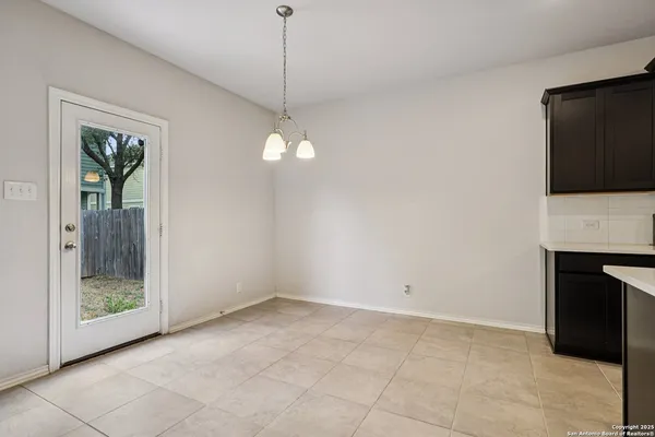 a view of an empty room with a fireplace and a window