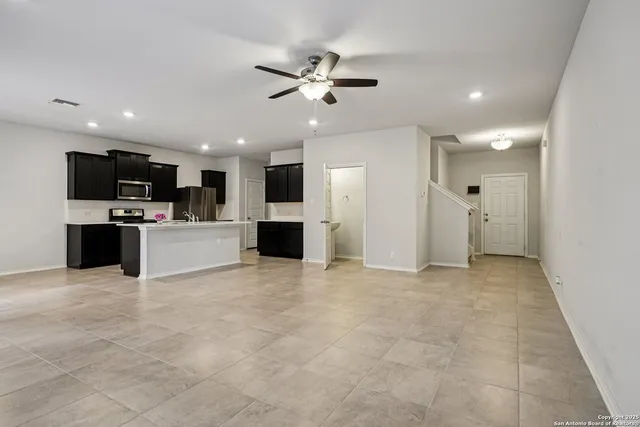 a view of an empty room with a kitchen