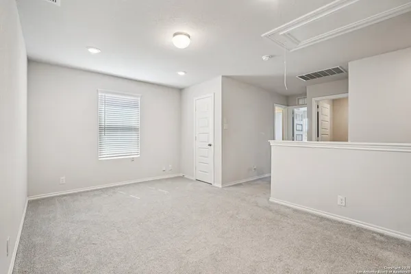 an empty room with windows and closet