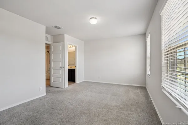 an empty room with windows and closet