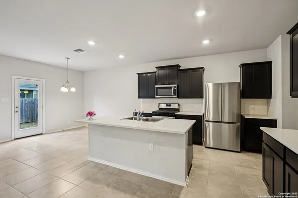 a kitchen with a sink stainless steel appliances and cabinets