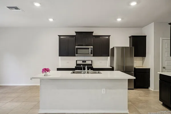 a kitchen with stainless steel appliances a refrigerator and a stove