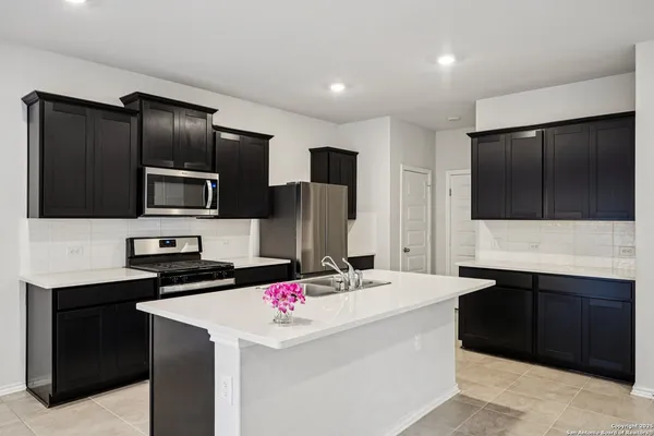 a kitchen that has a sink and a stove in it
