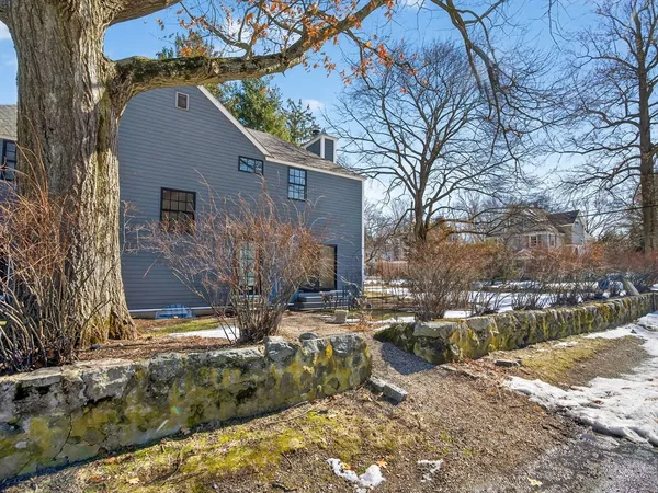 a view of a house with a yard covered in snow