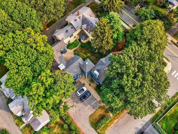 an aerial view of a house with a yard and garden