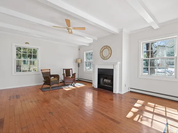 a living room with furniture a fireplace and a window